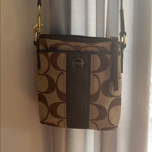 Couch satchel with shoulder strap and zips closed